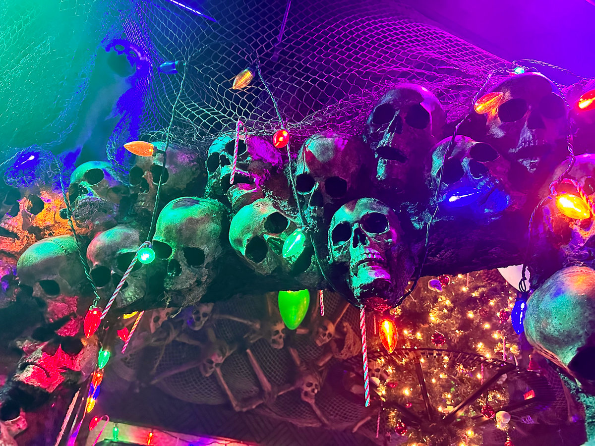 entryway lined with skulls on the ceiling